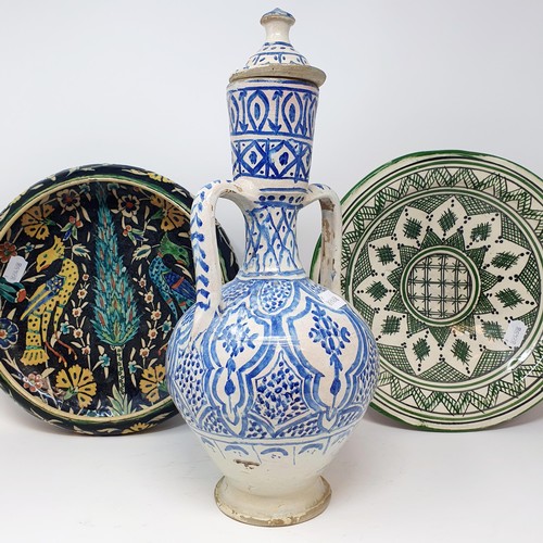 341 - An Eastern blue and white pottery ewer, with lid, 40 cm high, a bowl, 31 cm diameter, and an Iznik b... 