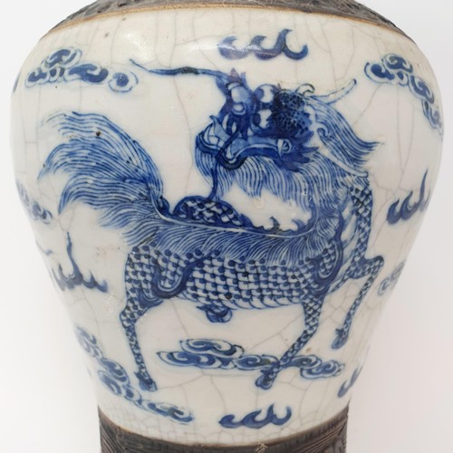 351 - A Chinese underglazed blue and white vase, with a crackled glaze, decorated mythical beasts, 38 cm h... 