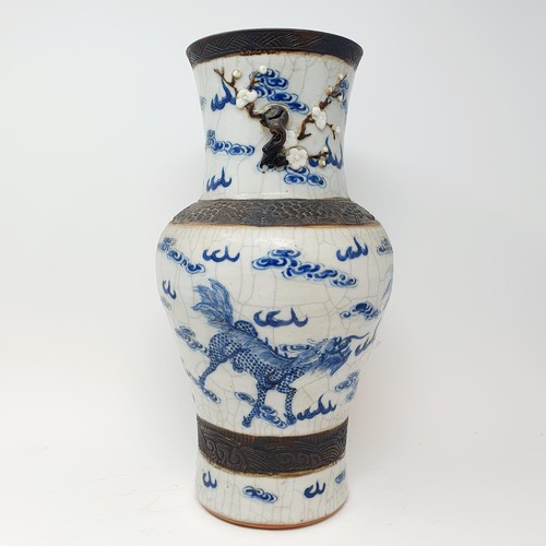 351 - A Chinese underglazed blue and white vase, with a crackled glaze, decorated mythical beasts, 38 cm h... 