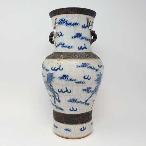 351 - A Chinese underglazed blue and white vase, with a crackled glaze, decorated mythical beasts, 38 cm h... 