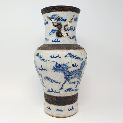 351 - A Chinese underglazed blue and white vase, with a crackled glaze, decorated mythical beasts, 38 cm h... 