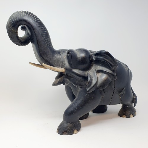 357 - An Asian carved wooden elephant, 47 cm wide, and three others smaller (4)