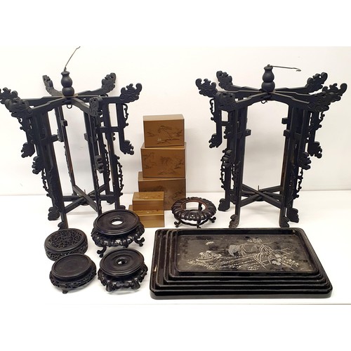 362 - A Chinese carved wood stand, a lid for a ginger jar, a graduated set of four trays, two lantern fram... 