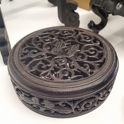 362 - A Chinese carved wood stand, a lid for a ginger jar, a graduated set of four trays, two lantern fram... 