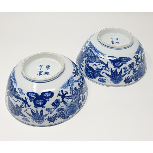 356 - A pair of Chinese porcelain bowls, decorated dragons and foliage in underglaze blue, four character ... 