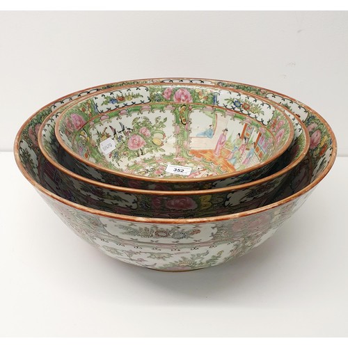 352 - A graduated set of three Cantonese famille rose bowls, 20th century, the largest 41 cm diameter (3)