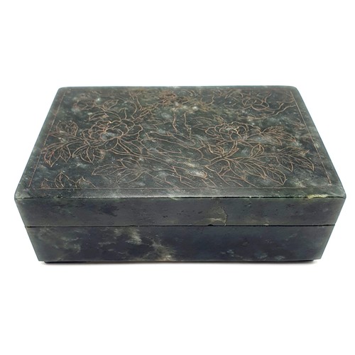 300 - A Chinese spinach-green jade box and cover, of rectangular form, the cover incised with a floral des... 