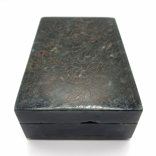 300 - A Chinese spinach-green jade box and cover, of rectangular form, the cover incised with a floral des... 