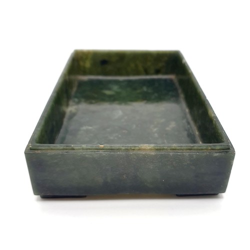 300 - A Chinese spinach-green jade box and cover, of rectangular form, the cover incised with a floral des... 