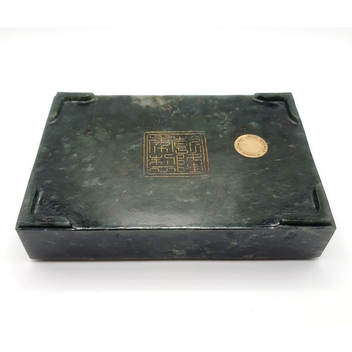 300 - A Chinese spinach-green jade box and cover, of rectangular form, the cover incised with a floral des... 