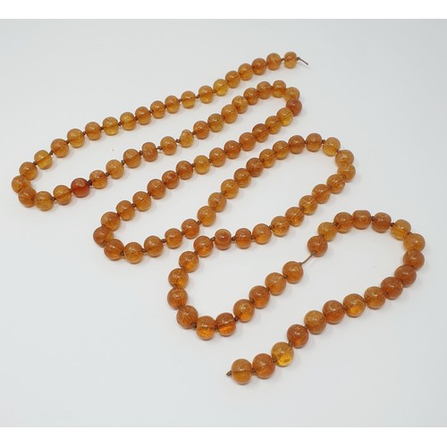 308 - An amber bead necklace consisting of 106 beads, and a painted glass bead on a tassle