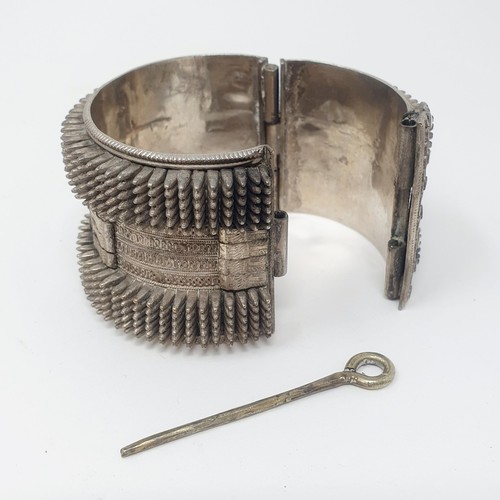 310 - An Eastern white coloured metal bangle