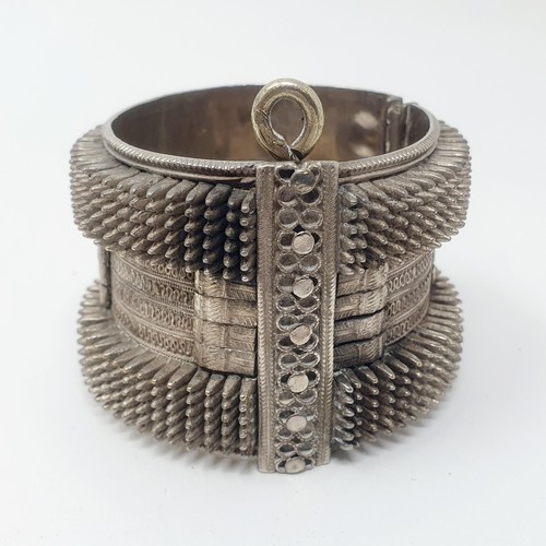 310 - An Eastern white coloured metal bangle