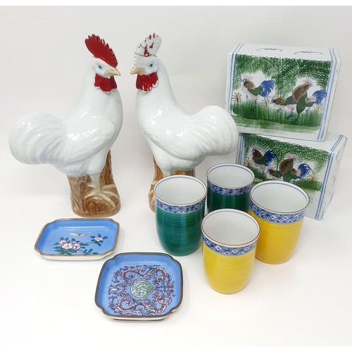 317 - A pair of Chinese cockerels, 25 cm high, two cushions, four beakers and two enamel dishes (10)