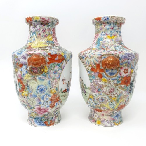 325 - A pair of Chinese famille rose vases, decorated flowers and with oval cartouches decorated figures, ... 