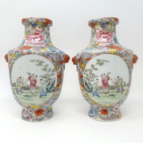 325 - A pair of Chinese famille rose vases, decorated flowers and with oval cartouches decorated figures, ... 