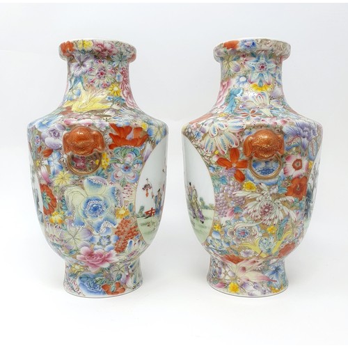 325 - A pair of Chinese famille rose vases, decorated flowers and with oval cartouches decorated figures, ... 