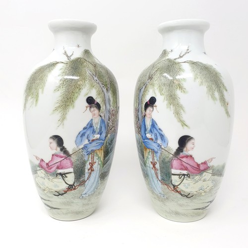 328 - A pair of Chinese vases, decorated figures, character mark to base, 14 cm high (2)