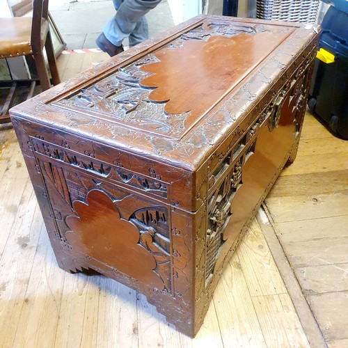 367 - A Chinese carved camphorwood chest, 105 cm wide