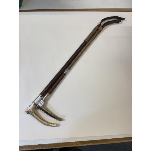 520 - A George V silver mounted horn and leather crop, 60 cm long, and another (2)