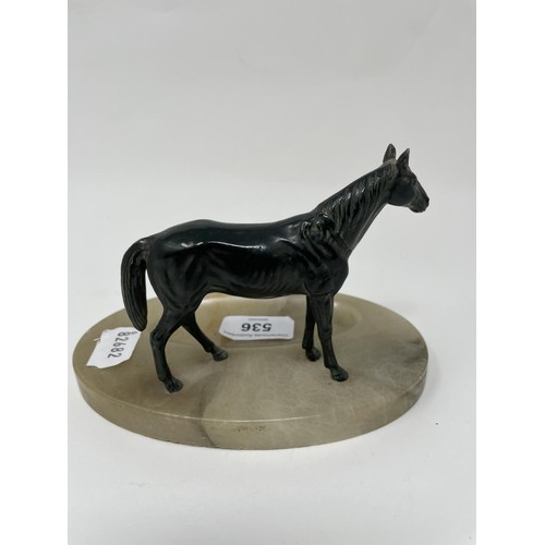 536 - An onyx desk stand, with a horse finial, 17 cm wide