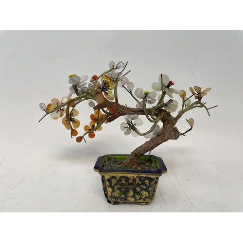 384 - A Chinese model of a tree, with glass petals, in a gilt metal enameled planter, 13 cm high