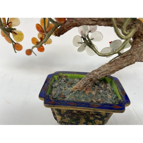 384 - A Chinese model of a tree, with glass petals, in a gilt metal enameled planter, 13 cm high