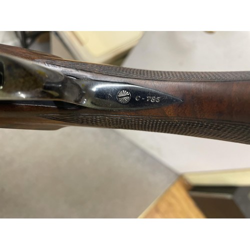 541 - A Baikal 12 bore over and under shotgun, and a slip case (2)
Note: This can only be released to the ... 