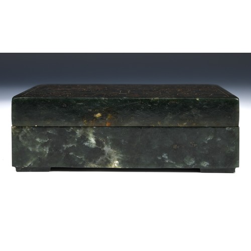 300 - A Chinese spinach-green jade box and cover, of rectangular form, the cover incised with a floral des... 