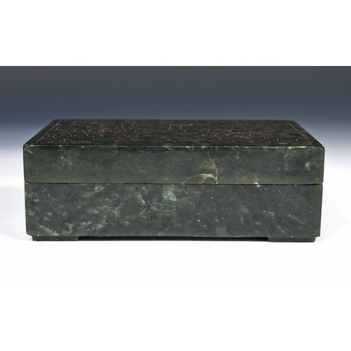 300 - A Chinese spinach-green jade box and cover, of rectangular form, the cover incised with a floral des... 