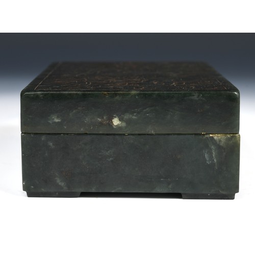 300 - A Chinese spinach-green jade box and cover, of rectangular form, the cover incised with a floral des... 