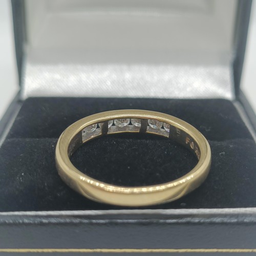 117 - An 18ct gold and diamond half eternity ring, ring size O