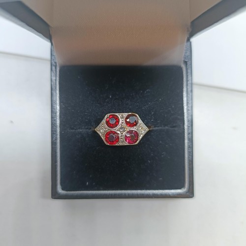 120 - A 9ct gold diamond and garnet four stone ring, ring size O 1/2