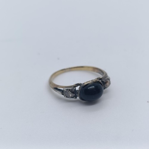 123 - An early 20th century cabochon cut blue and white stone ring, ring size K