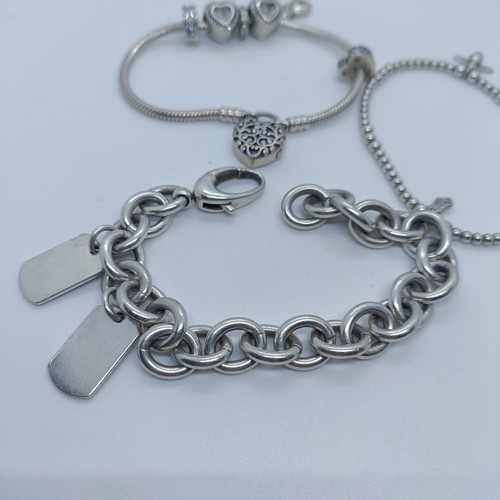 113 - A silver bracelet, with dog tags, and two other bracelets