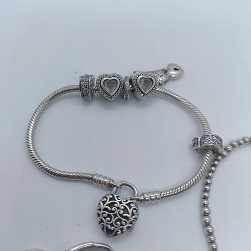 113 - A silver bracelet, with dog tags, and two other bracelets