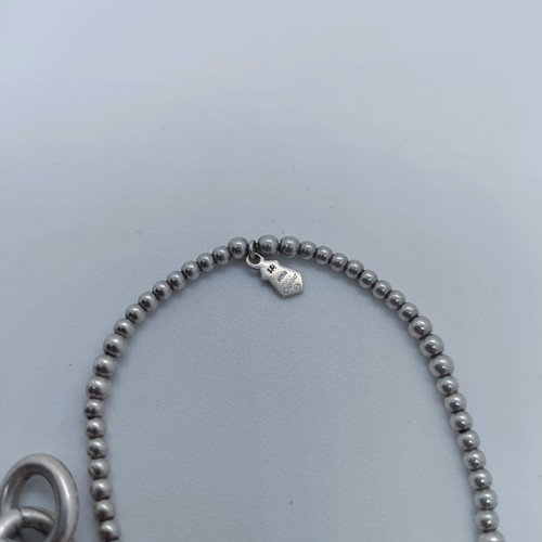 113 - A silver bracelet, with dog tags, and two other bracelets