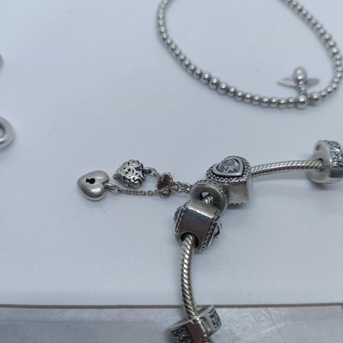 113 - A silver bracelet, with dog tags, and two other bracelets