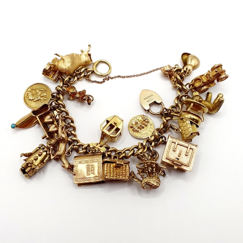 1 - A 9ct gold charm bracelet, all in 84.5 g