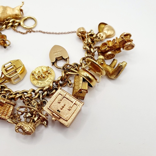 1 - A 9ct gold charm bracelet, all in 84.5 g