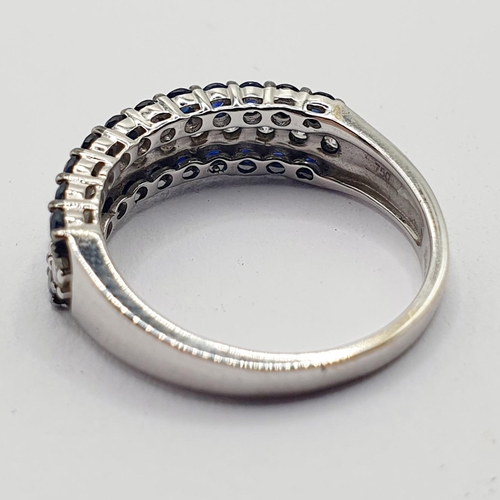 14 - An 18ct white gold, sapphire and diamond half eternity ring, ring size M