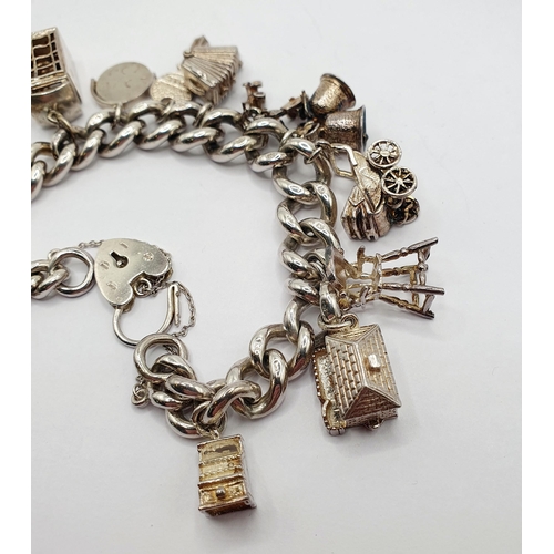 167 - A silver charm bracelet, and various charms, 82.6 g