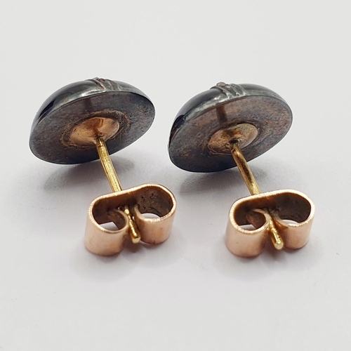 21 - A pair of early 20th century stud earrings, in a vintage jewellery box