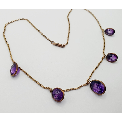 30 - A yellow metal and amethyst necklace  Provenance: From a large single owner collection of jewellery ... 