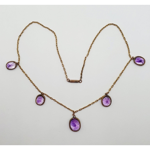 30 - A yellow metal and amethyst necklace  Provenance: From a large single owner collection of jewellery ... 