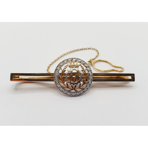 31 - A yellow metal and diamond tie pin, a central with crest, surrounded by a ring of diamonds. Provenan... 