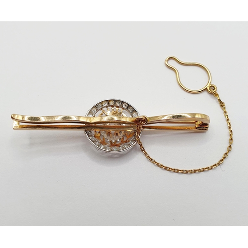 31 - A yellow metal and diamond tie pin, a central with crest, surrounded by a ring of diamonds. Provenan... 