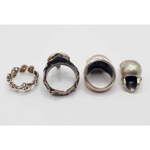 40 - A silver coloured metal gentleman's ring, in the form of a scorpion, two other rings, and a skull pe... 