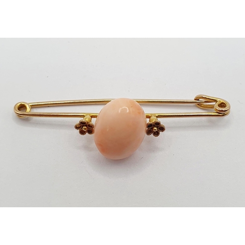 48 - A yellow metal and pink stone bar brooch