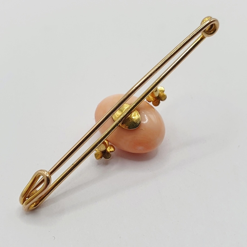 48 - A yellow metal and pink stone bar brooch